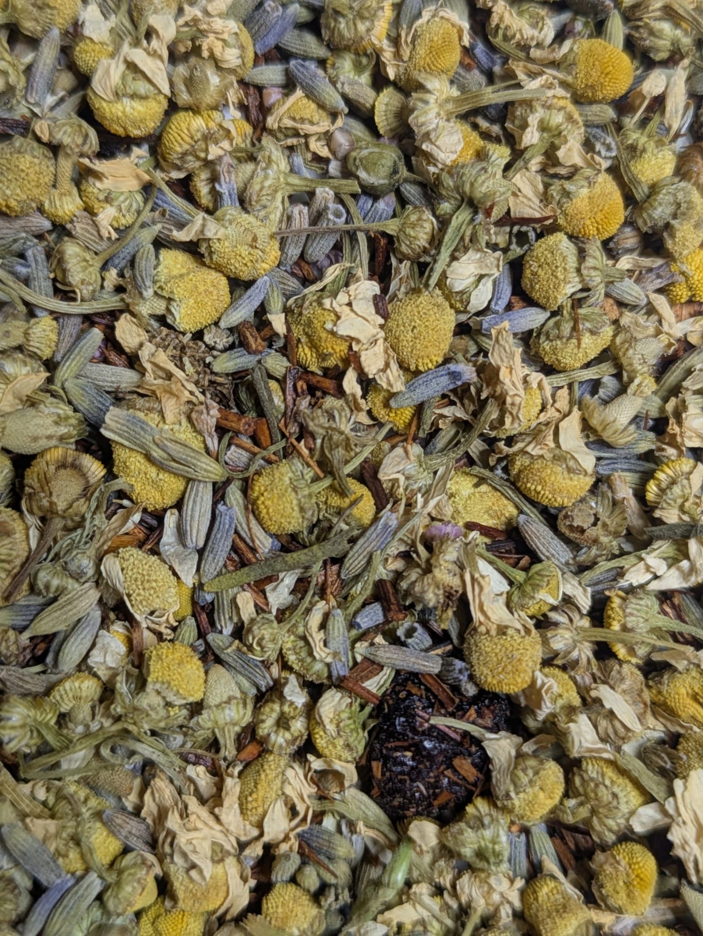 Close-up of dried herbs and flowers including chamomile and lavender and cherry.