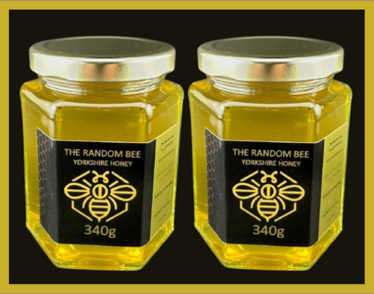 Two jars of Yorkshire honey from The Random Bee on a black background