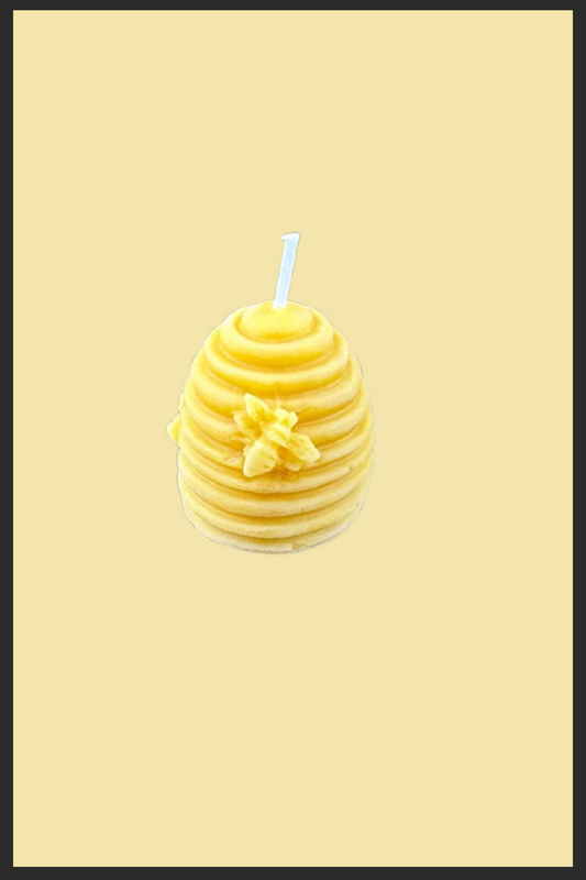 Yellow candle with a blue wick on a beige background